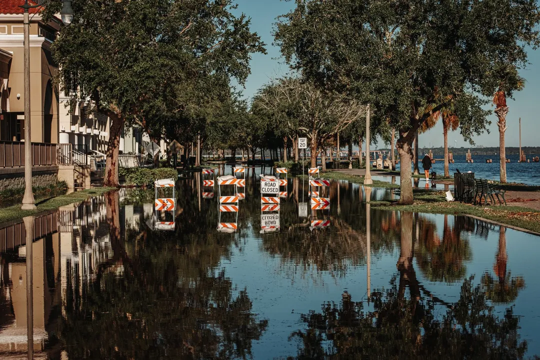 Flooded waterfront street closed off with road-closed barricades